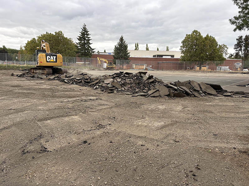Heavy equipment excavating old concrete on a tennis court